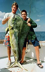 George McElveen, left, mate on the Catch 22, helps Nick Stanczyk, 16, hold a 51.5-pound bull dolphin that Stanczyk battled for 5 1/2 hours and landed on 15-pound-test tippet fly tackle.